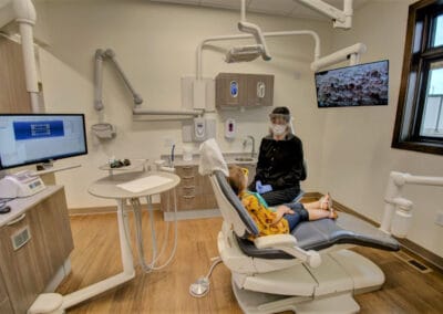 Dr. Reyerson is seated with child during dental exam angle 2